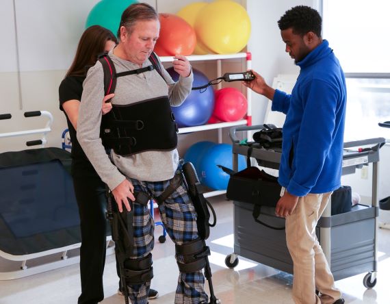 A patient uses robotic technology to walk again after injury.