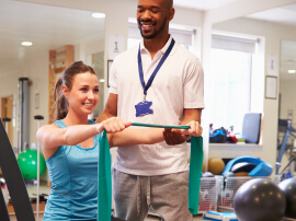 A patient doing physical therapy exercises with a physical therapist. 