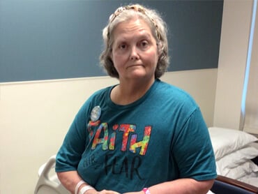 Delvia McMillin stands proudly after rehabilitation.