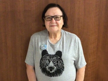 Glenda Huacuja stands after therapy session.
