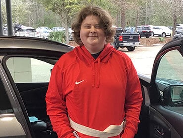 Haedyn Head stands by his car after physical therapy.
