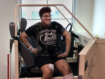 Megan Simon practices in the therapy car in the gym.